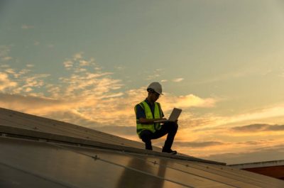 Engineer working setup Solar panel at the roof top. Engineer or worker work on solar panels or solar cells on the roof of business building